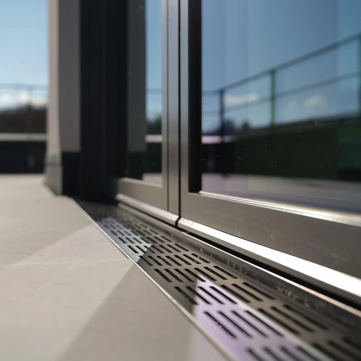 Drainage channel UD Pro black lifestyle image in front of patio door